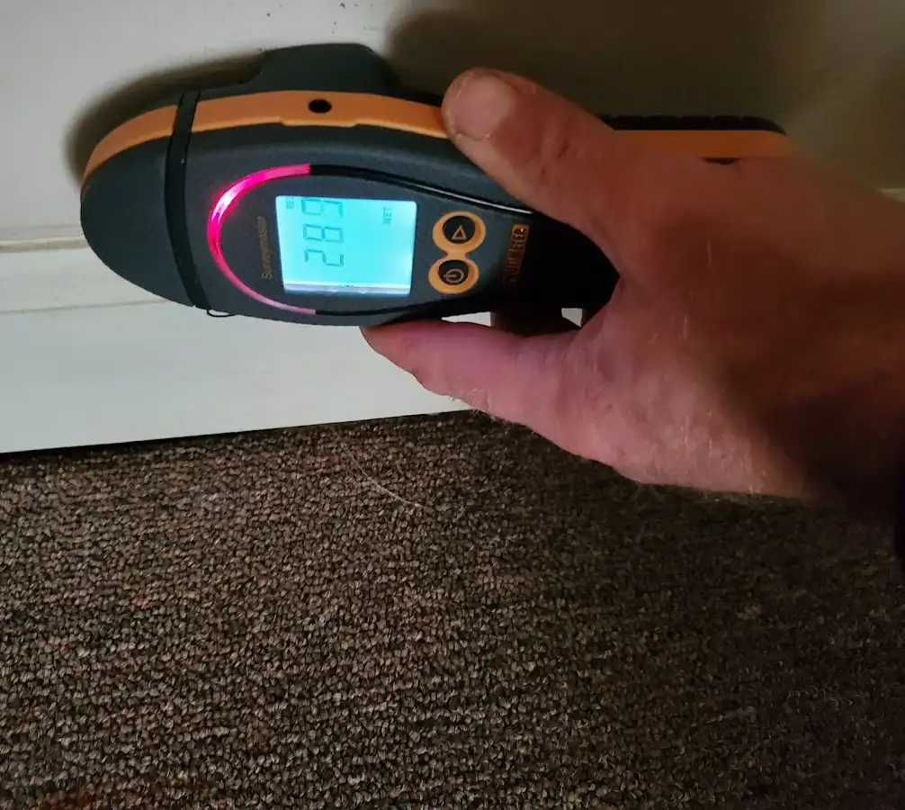 Moisture detection at baseboard during Storm Damage Restoration in Chickasaw